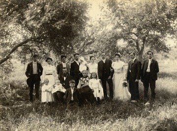 Outdoor portrait of James Sutter and his family, none of the family members are identified.
