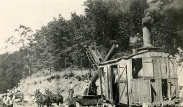 Erie steam shovel or excavator being used to remove dirt for the road bed.