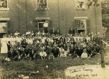 Unidentified staff and students of all ages gathered outside of the school for a picture.