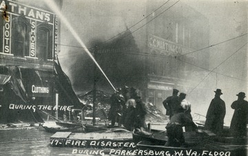Firemen attempt to control the fire at Nathan's Clothing Store from a boat.