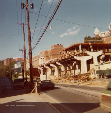 Construction of Beechurst PRT station as seen from across Beechurst Ave. Summit Hall and Armstrong Hall in background. Top of Woodburn Hall visible on the far right.