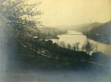 The Monongahela River flows past Morgantown, the Supension Bridge in the background spans the river to Westover.