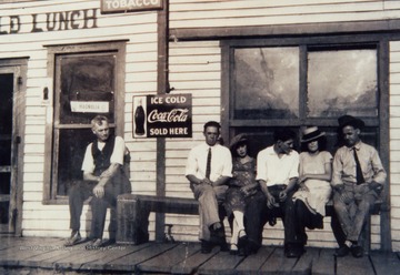 Identified in the photograph, sitting on the right are W.L. Elkins and Lloyd Elkins.