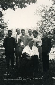 U.S. geological surveyer, Samuel Garnett, who was hired to mark the north-south state boundary of West Virginia and Maryland gets his hair cut while others await their turn.