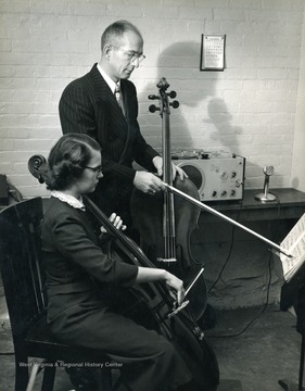 Student being taught to play the up-right bass in what was once West Virginia University's music department, now known as the creative arts department.