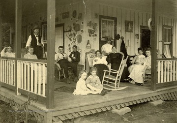 From left to right: Aunt Ann, Mother, Father, James, Harry, Hale, Margaret, Mrs. Dyke, Grace(in window), Grandma, Anne, Daisy