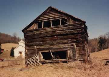 Side view of the Joseph Tennant log house across road from Methodist Church at Jakes Run, West Virginia.