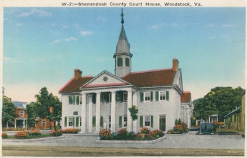 Colored postcard photograph of the oldest court house still in use west of the Blue Ridge Mountains. The structure was designed by Thomas Jefferson and built in 1795.