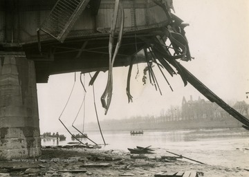 Soldiers in the background cross the Neckor River in Mannheim, Germany. Destroyed bridge is in the foreground.