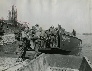 Information on back of photo reads: "3rd U.S. Army Troops go aboard LCVP prior to first crossing of the Rhine River by soldiers of the 3rd Army at Nierstein, Germany. Soldiers are members of the 5th Infantry Division."