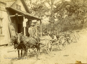 Notes on back of photograph: "Uncle Edgar Lucher (3rd on porch), Uncle Ira Lucher (And first wife, who's name is unreadable), Uncle Sam Fordham and Clara Lucher (daughter of Aunt Nina)." Note the nets over the horses' ears to keep flies out.