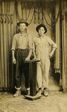 Two "woodhicks" or otherwise known as lumberjacks Okey Selmon and Boggs M. pose for the camera.