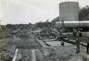 Built in the wake of the devastating Flood of 1937, when the Ohio River crested at more than 19 feet above flood stage at Huntington. The flood wall was built in 3 separate sections. Shown here is the Guyandotte Section under construction.