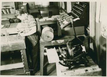 Donovan Bond works in Daily Athenaeum's type lab.  Bond subsequently became a Professor of Journalism at WVU.