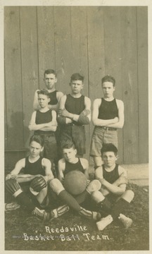 Team photograph of grade-school age boys in uniform.