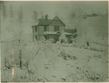 Winter scene at a family home, several unidentified people pose outside.