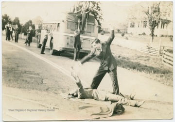 Donovan Bond and unidentified friend pretending to fight, while others on the Debate Team pack the bus for travel.