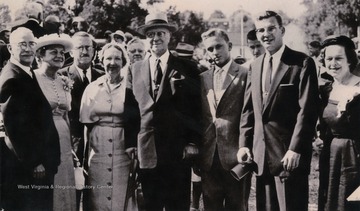 Caption on original photo reads: "The last group picture of the Benedum family, taken at the dedication of the Civic Center in Bridgeport in July 1957. Left to right: Paul and his wife Willeen, Claxton, Clora (Mashburn), Mr. Benedum, Michael Late Benedum, II, son of Darwin, Paul G. Benedum Jr., and Eugenia (Mrs. Darwin Benedum).Michael Benedum was considered the modern day founder of Bridgeport, W. Va. After 70 years of working in the oil and gas industry, Benedum created many projects to restore and beautify the city of Bridgeport."