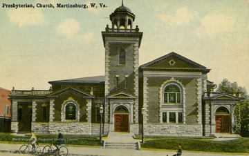 Children ride their bikes past the church. Published by Louis Kauffman &amp; Sons. (From postcard collection legacy system.)
