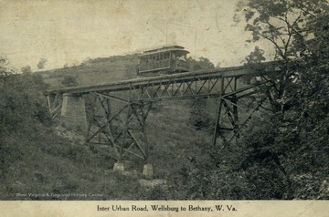 Trolley travels over bridge on inter urban road. (From postcard collection legacy system.)