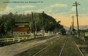 Train car picks up passengers outside of the entrance to Clyffeside Park. Published by J.G. McCrorey. (From postcard collection legacy system.)