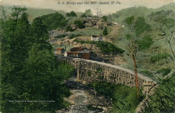 Hand colored depiction of bridge crossing through mill. See original for correspondence. Published by Adolphs Selige Publishing Co. (From postcard collection legacy system.)