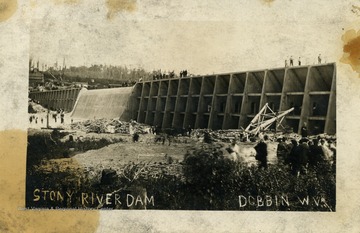 People visit the Stony River Dam, observing from the top and bottom. (From postcard collection legacy system.)