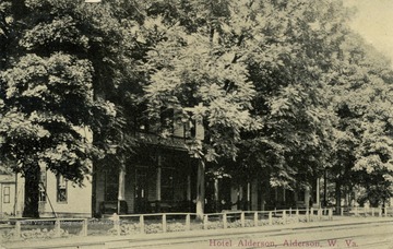 A handful of trees shade the entrance of Hotel Alderson. See original for correspondence. Published by Alderson Book Store. (From postcard collection legacy system.)