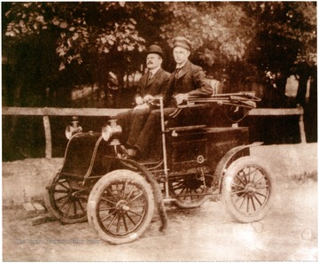 The vehicle was owned by Andrew (A. C.) Lyons seated on the right with the control stick in hand. Lyons was a turn of the century architect working in  Fairmont.  The man seated next to Lyons is not identified.