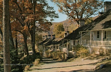Caption on back of postcard reads: "A resort that's a way of life. These small white cottages, built in the early part of the 19th Century, now house The Greenbrier Creative Arts Colony, featuring demonstrations and instruction in the handicrafts." Published by Club Photos. (From postcard collection legacy system.)