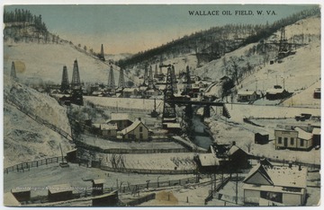 Scene of several oil derricks among pump houses and homes during the "Great West Virginia Oil Boom". See original for further oil field information. (From postcard collection legacy system.)