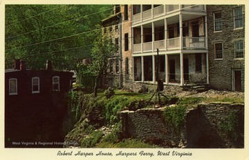 Caption on back of postcard reads: "The small house at left of row shows Robert Harper House at Harpers Ferry, West Virginia, as it looks today." Published by Grafton Souvenir. (From postcard collection legacy system.)