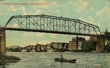 Man travels past bridge on his canoe. See original for correspondence. (From postcard collection legacy system.)