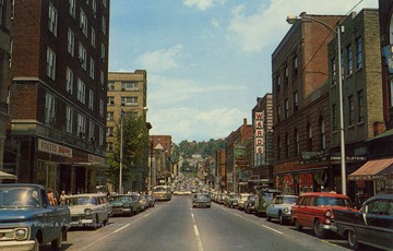 Caption on back of postcard reads: "Downtown Morgantown, W. Va. This industrial city is a distributing point in the heart of a rich agricultural and coal mining district, and the home of the University of West Virginia." Published by Valley News Agency Inc. (From postcard collection legacy system.)