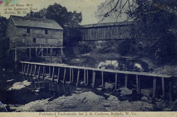 Covered bridge in distance and dam in foreground next to mill. Published by W.H. Stanage and Company. (From postcard collection legacy system.)