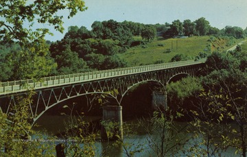 Caption on back of postcard reads: "Rumsey Bridge spanning the historic Potomac at Shepherdstown, W. Va. This bridge, connecting West Virginia and Maryland, was officially opened with appropriate ceremonies and pageant, depicting James Rumsey trying out his steam propelled boat, July 15, 1939. The hill in the background is Ferry Hill and lies in the state of Maryland. This bridge replaced a toll bridge destroyed by the disastrous flood of 1936." Published by Naturecraft. (From postcard collection legacy system--subject.)