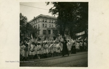 Sunday School children parade around waving American flags. (From postcard collection legacy system--subject.)
