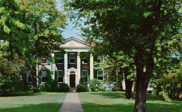 Caption on back of postcard reads: "This handsome southern home known as "Waldomore", and the spacious grounds surrounding it, situated in the heart of Clarksburg, West Virginia were devised to the city in 1930 by Mrs. May Goff Lowndes, for use as a public library and museum. The home was built 1839, by her father Waldo P. Goff. The name "Waldomore" was given to the property by Mrs. Lowndes in honor of her father and mother. The city's public library was established in 1907 and has been permanently located in Waldomore since 1931." Published by Rex Heck News Company. (From postcard collection legacy system--subject.)