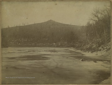 Photo of Dorsey's Knob from the partially frozen river.