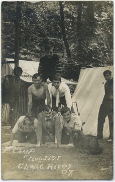 Group of boys gather to form a human pyramid.