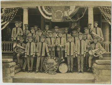 Members gathered around a band drum that reads, "Elks Band: B.P.O.E. No. 411, Morgantown, W. Va."