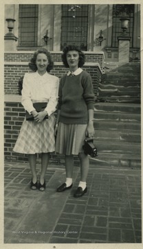 Two female students stand in front of what is now known as Wise Library.