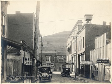 Gatrell and Parish Junk Dealers shop on the right, next to Drs. Nicholson and Carder Veterinary Surgeons, and The Herald Express building. Drug store straight down the street and bakery on the left of Water Street.