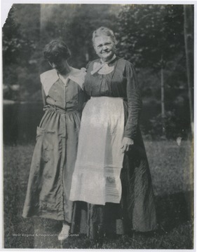 Susan Catherine Finnell Johnson, mother of Mrs. Lucy B. Johnson, and Mrs. Anna Fitch pose in front of the house located on Rockley Road in Morgantown, W. Va.