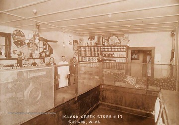 Produce and various grocery items behind the counters.