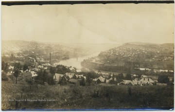 View of the Monongahela River running through the house covered hills of the city.  