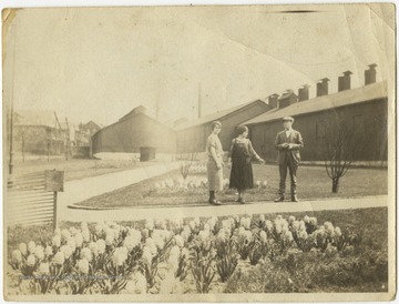Unidentified children stand in front of the mill facilities. 