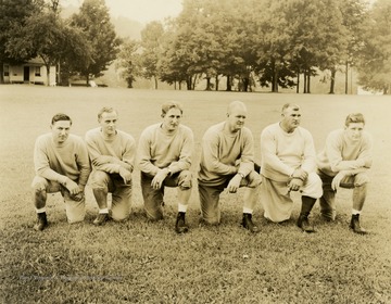 Print number 221. From left to right: Frank Kultz, guard coach; Mike Nicksick, back coach; Eddie Hirschberg, assistant coach; Bill Kern, head coach; Errett Rodgers, back coach and scout; Ray Carnelly, freshman coach.