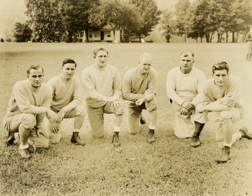 Print number 222. From left to right: Frank Kultz, guard coach; Mike Nicksick, back coach; Eddie Hirschberg, assistant coach; Bill Kern, head coach; Errett Rodgers, back coach and scout; Ray Carnelly, freshman coach.