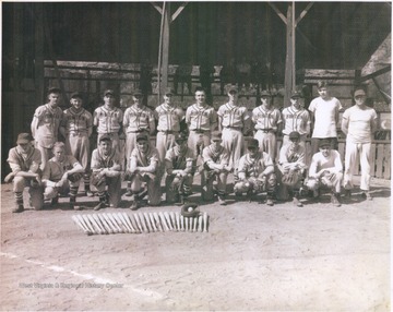 Victorious Hinton baseball team pose behind their neatly lined up baseball bats. Subjects unidentified. 